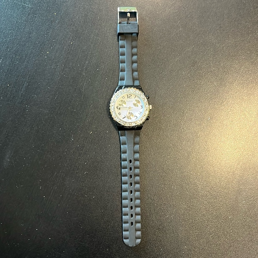 Watch with black rubber band and rhinestones around face